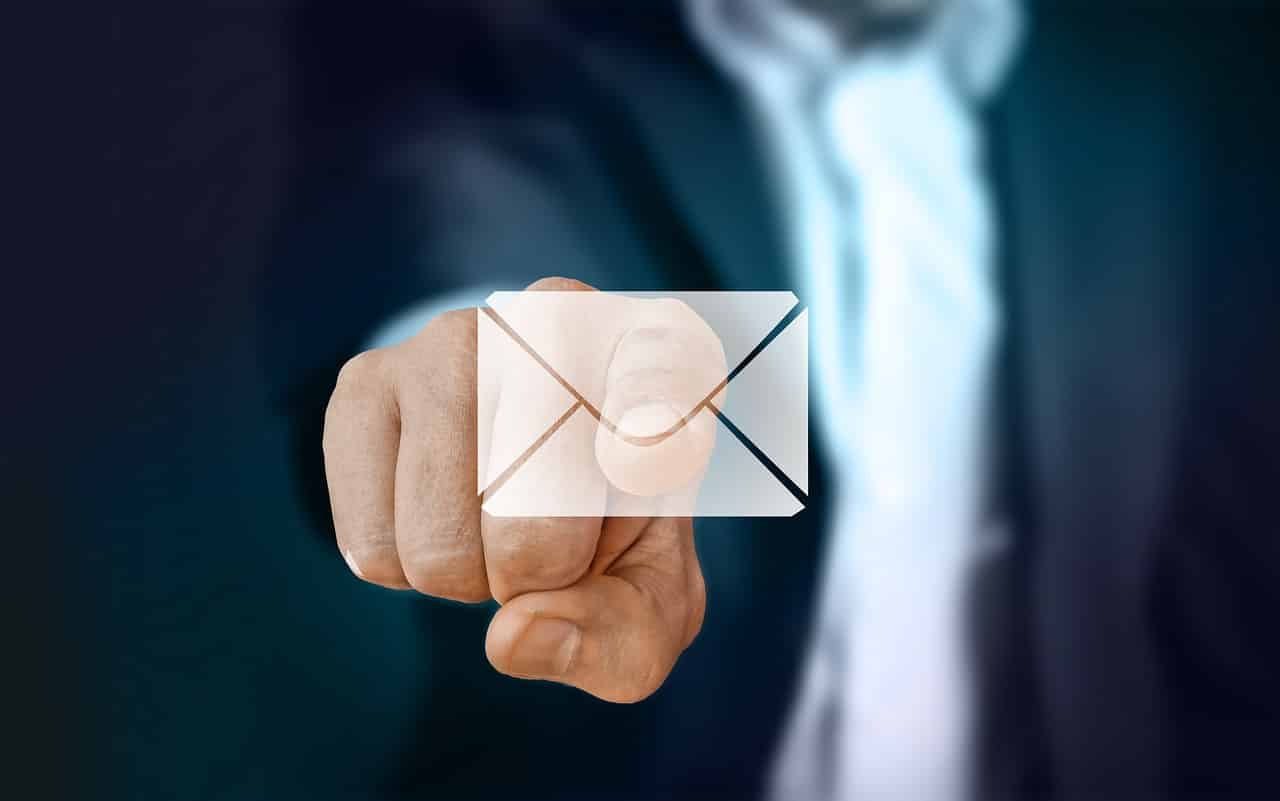 Businessman in suit pressing an envelope icon with his index finger