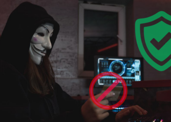 A masked scammer trying to commit online fraud by stealing credit card information but is blocked online by a store with comprehensive merchant fraud protection strategy in place