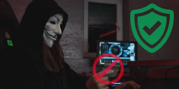 A masked scammer trying to commit online fraud by stealing credit card information but is blocked online by a store with comprehensive merchant fraud protection strategy in place