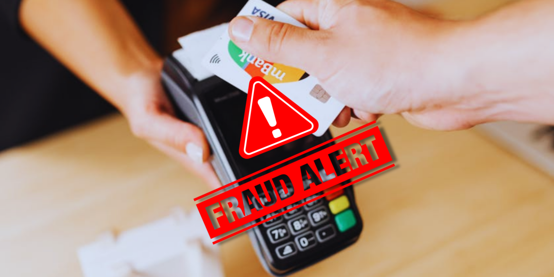 A fake credit card tapped in a machine, depicting a merchant fraud in action