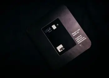 A black Visa Infinite card on its mailer, illustrating the Visa network at the center of its penalty against Hims & Hers over chargeback disputes