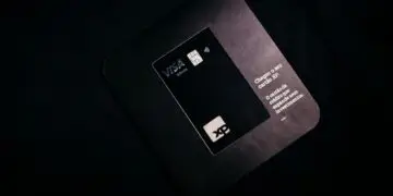 A black Visa Infinite card on its mailer, illustrating the Visa network at the center of its penalty against Hims & Hers over chargeback disputes