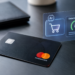 Stock photo of a black Mastercard on a dark desk beside a holographic display showing an “AI” icon, a shopping cart icon, and a “Detection Score” gauge reading 87, illustrating AI-powered fraud detection in card transactions.
