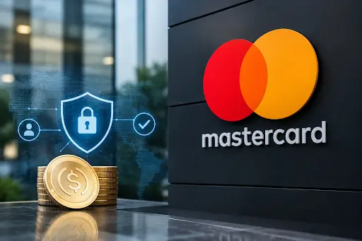 Stock photo of gold coins stamped with a dollar sign beside a digital security shield icon with a padlock, displayed near a large Mastercard logo on a dark wall, symbolizing secure digital payments.