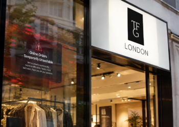 TFG London fashion retailer storefront featuring the brand’s black-and-white logo above glass display windows, with a red cybersecurity warning graphic stating “Online Orders Temporarily Unavailable” to represent a cyberattack disrupting online orders.